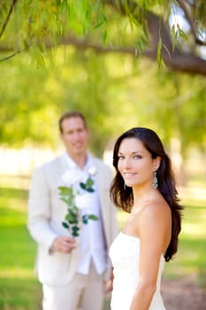 couple just married with man holding flowers in hand