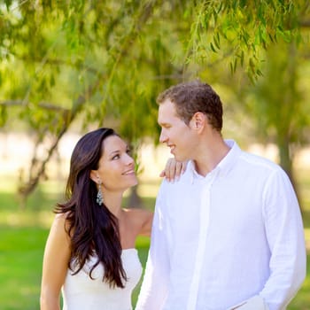 couple in love happy in green park outdoor under trees