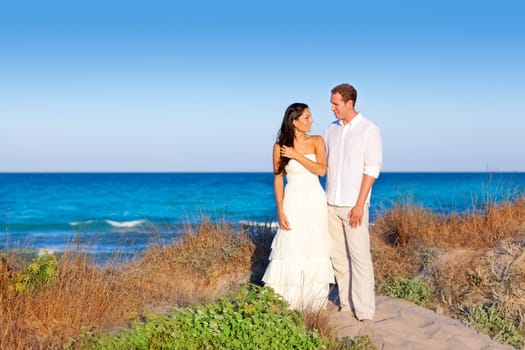 couple in love in the beach dune on Mediterranean sea