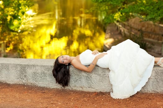 Woman lying in autumn golden forest river outdoor