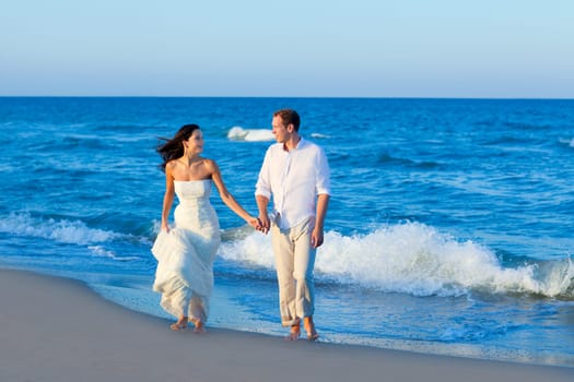 Mediterranean couple walking in blue beach shore