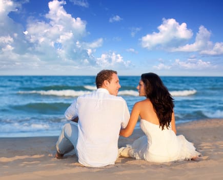 couple in love sitting in blue beach on vacation travel