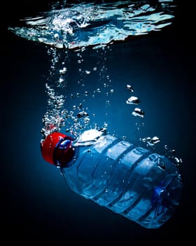 Bottled water on a black/blue background with air bubbles