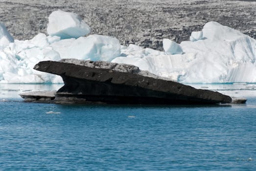 dirty icebergs  of lava floating on the Jokulsarlon lake in Iceland