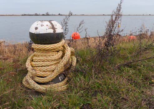rope around a bollard on a lake side