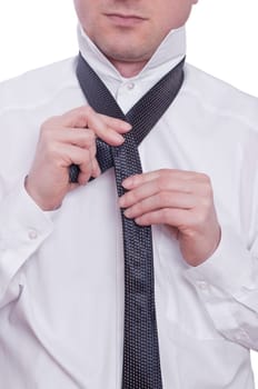 A man ties a tie