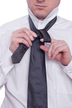 A man ties a tie
