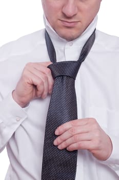 A man ties a tie