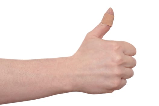 A man holds his thumb up with plaster