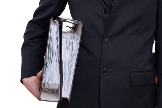 A man in a suit holds two folders under his arm