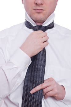 A man ties a tie