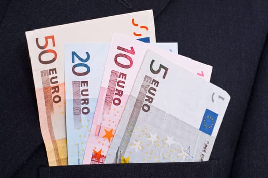 Euro bills stuck in the pocket of a suit