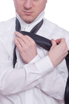 A man ties a tie