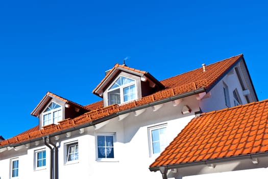 generic family home in suburban area with blue sky