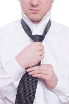A man ties a tie