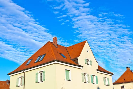 generic family home in suburban area with blue sky