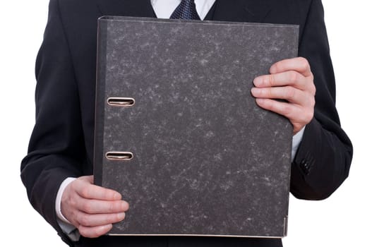 A folder and two hands of a man in a suit