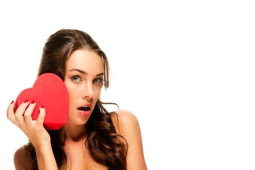 Beautiful brunette woman holding red heart against white background