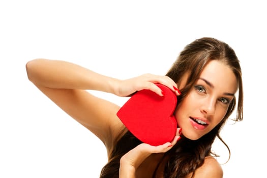Beautiful woman holding red heart against white background