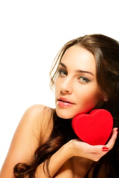 Beautiful brunette woman holding red heart against white background