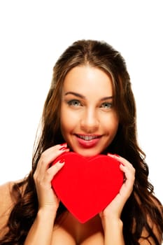 Beautiful laughing woman holding red heart against white background