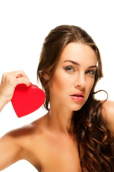 Beautiful woman holding small red heart against white background
