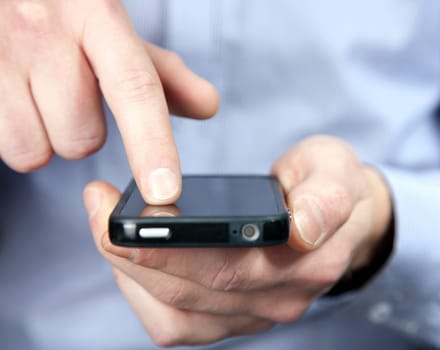 Hands of a man using a smartphone