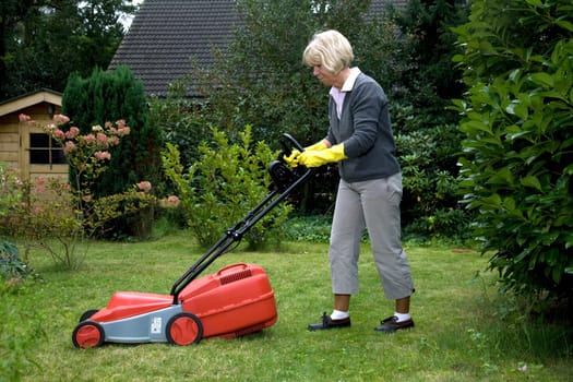 Senior citizen mows lawn