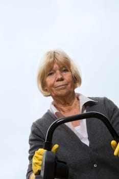 Senior citizen mows lawn
