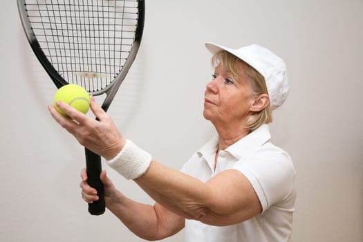 Senior woman playing tennis