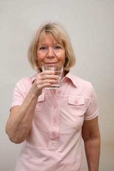 Senior woman with glass of water