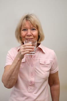 Senior woman with glass of water