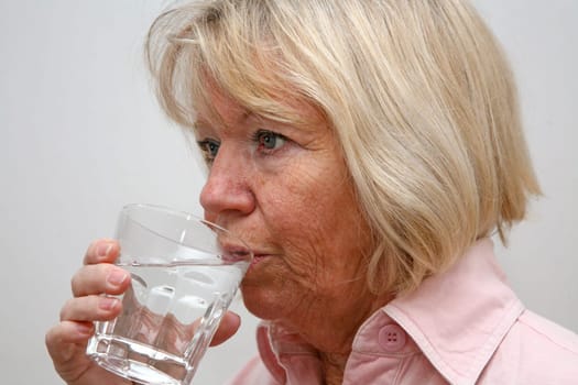Senior woman with glass of water