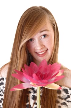 A lovely young teenage girl in a portrait picture with a pink water lily, smiling into the camera, with long hair for white background.