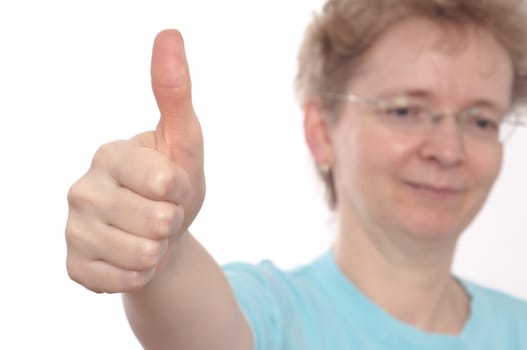 A blonde woman with glasses holds up the thumbs up