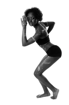 Beautiful African indigenous tribal ethnic fashion female with white dots and stripes standing, isolated.