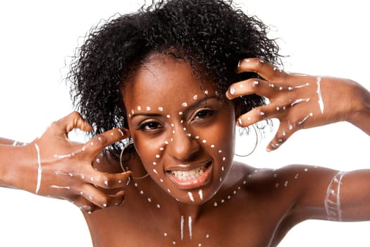 Beautiful African indigenous tribal fashion female face with white dots and stripes and aggressive expression, isolated.