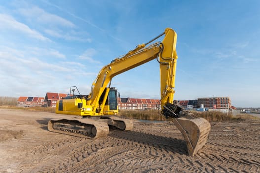 excavator in front of a newly build residential area