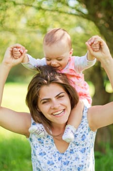 happy mother with her child on her shoulders