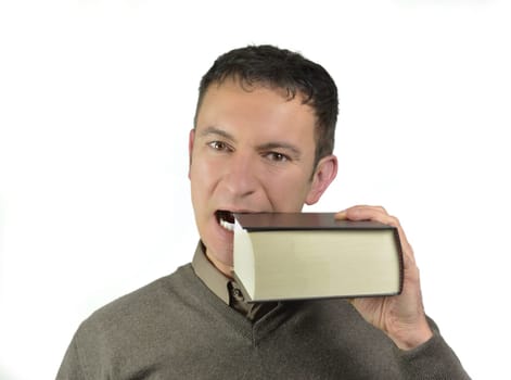 Handsome young man bites a big book