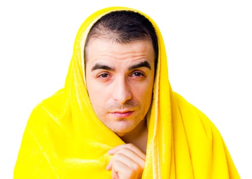 Sick man with fever in a yellow blanket