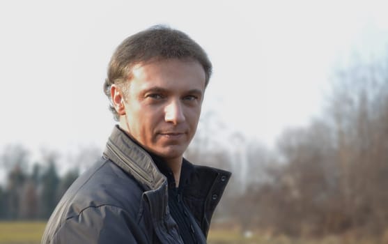 Handsome man portrait in a field