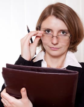 A businesswoman with glasses and clipboard