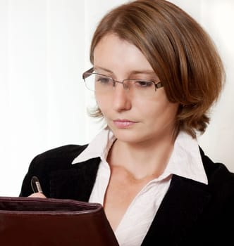 A businesswoman with glasses and clipboard