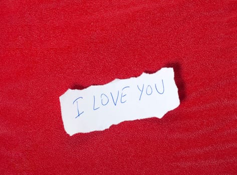 Ripped paper on red background with message of love