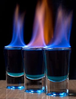 Burning drink in shot glass on a table