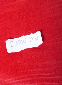 Ripped paper on red background with message of love