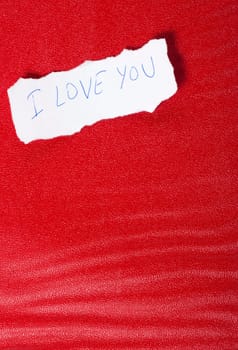 Ripped paper on red background with message of love