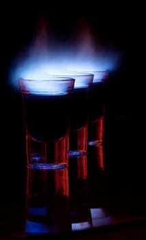 Burning drink in shot glass on a table