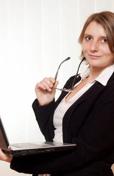 A businesswoman with glasses and clipboard
